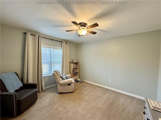 sitting room featuring light carpet and ceiling fan