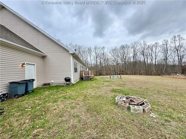 view of yard with an outdoor fire pit