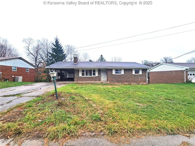 ranch-style home with a carport, central AC unit, and a front yard