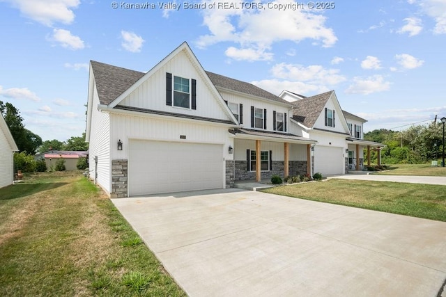 view of front of house with a porch, a garage, and a front lawn