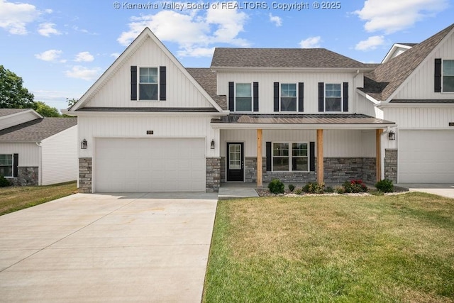 view of front of property featuring a garage, covered porch, and a front yard