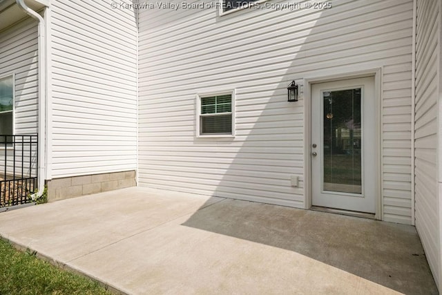 property entrance featuring a patio area