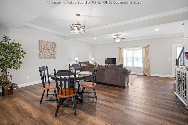 dining space featuring ceiling fan with notable chandelier, dark hardwood / wood-style floors, and crown molding