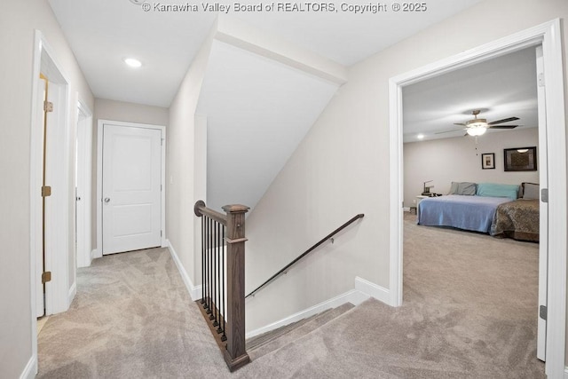 hallway featuring light colored carpet