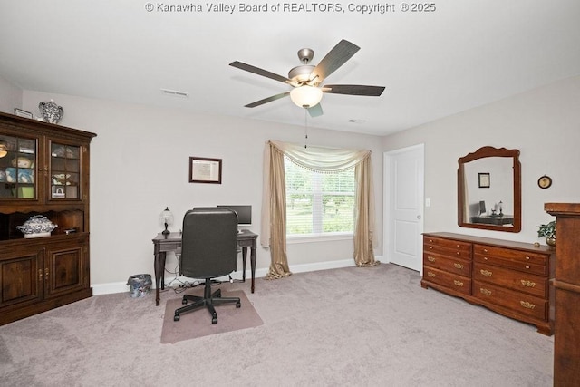 home office featuring ceiling fan and light carpet