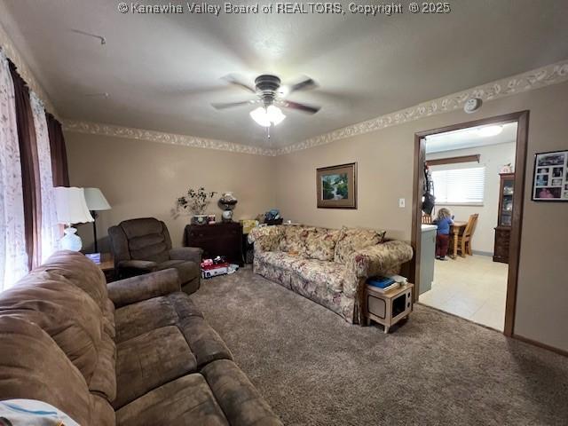 living room with ceiling fan and light colored carpet