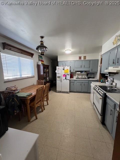 kitchen featuring gray cabinetry, range with electric cooktop, and white fridge with ice dispenser