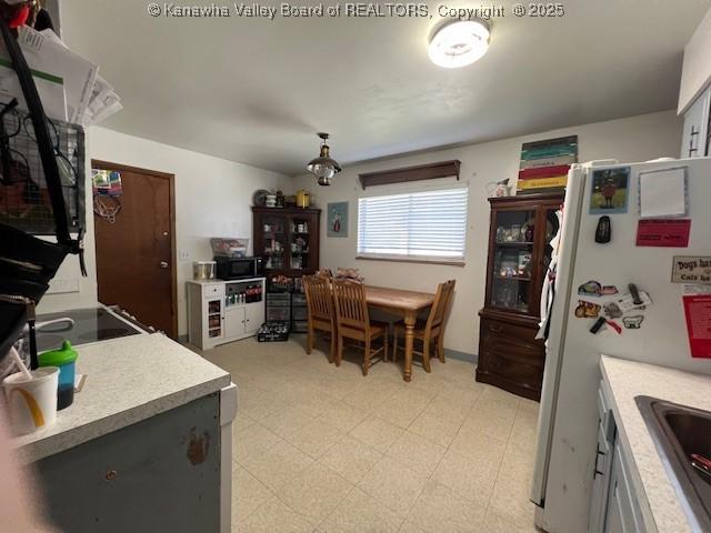 kitchen featuring gray cabinets, white refrigerator, range, and sink