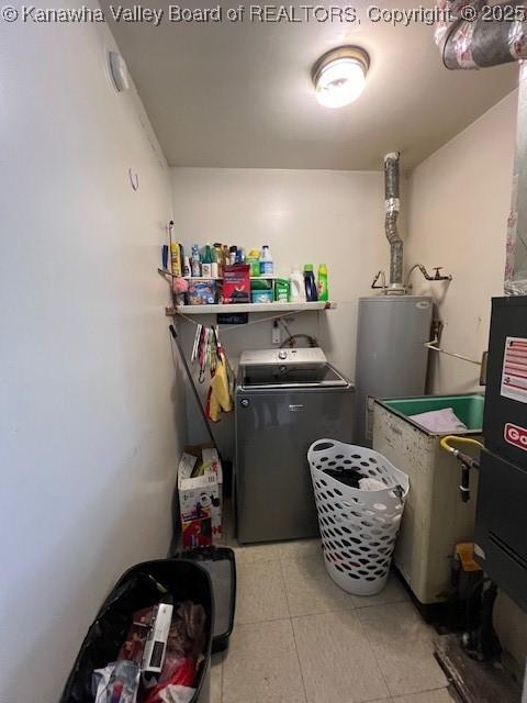 laundry area with independent washer and dryer and water heater