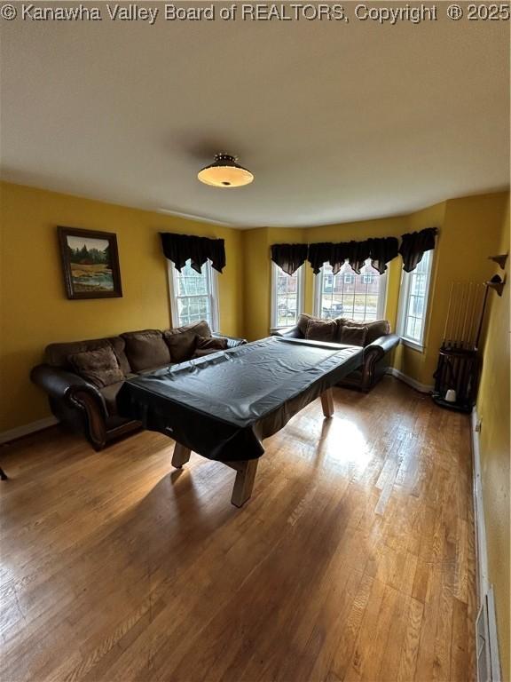 game room with light hardwood / wood-style floors and pool table