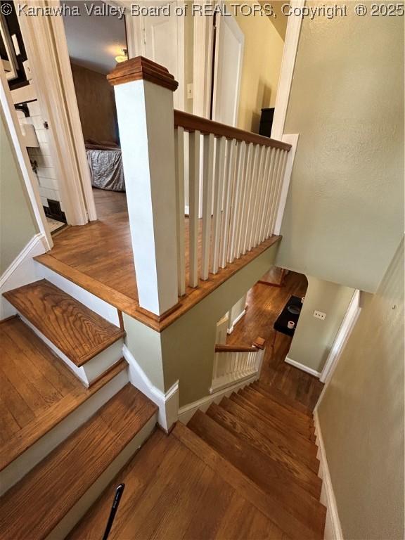 stairway featuring hardwood / wood-style flooring