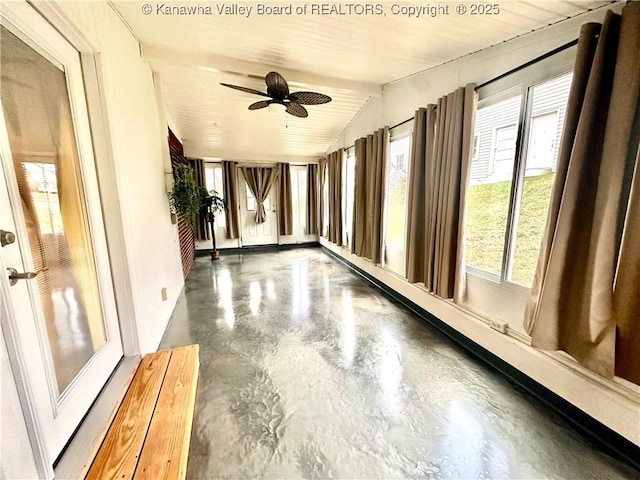 unfurnished sunroom featuring ceiling fan