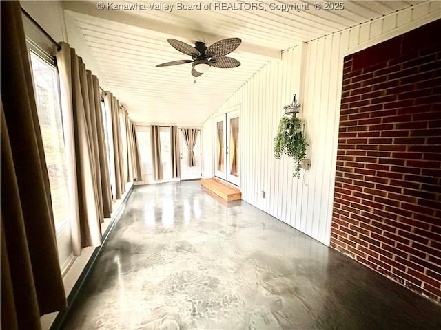 unfurnished sunroom featuring plenty of natural light and ceiling fan