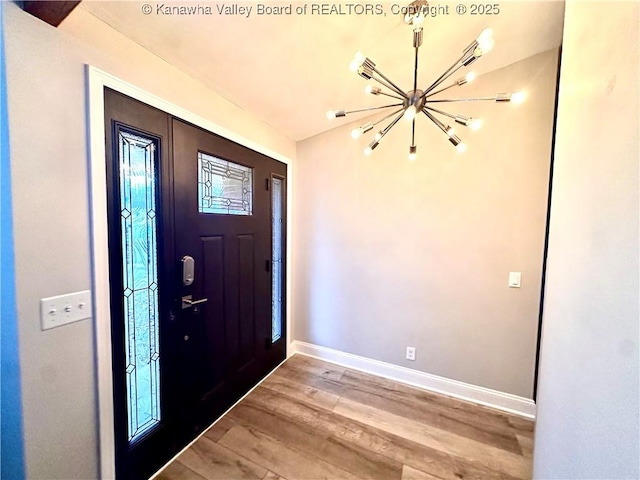 entryway featuring a notable chandelier and wood-type flooring