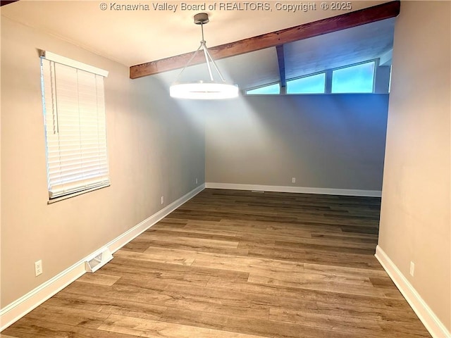 unfurnished dining area featuring vaulted ceiling with beams and hardwood / wood-style flooring