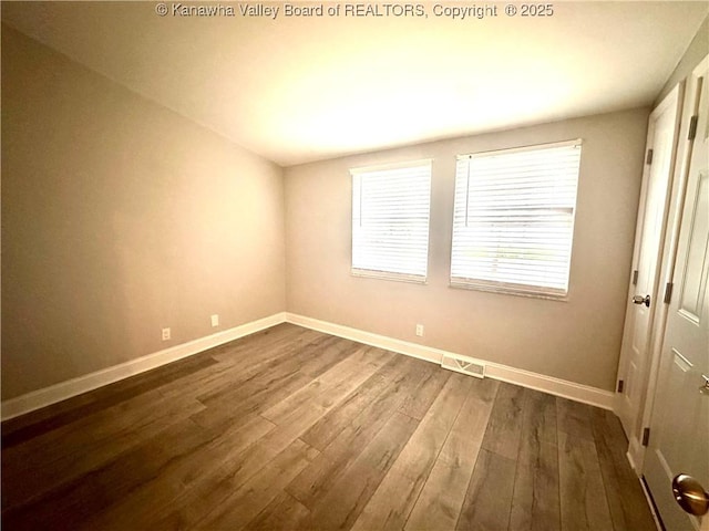 unfurnished room featuring hardwood / wood-style flooring