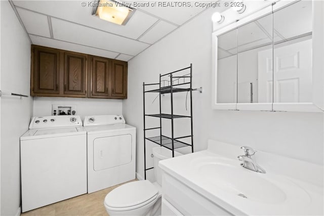 bathroom featuring a paneled ceiling, vanity, toilet, and separate washer and dryer