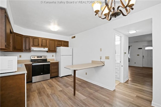 kitchen with light wood-type flooring, white appliances, hanging light fixtures, and a chandelier