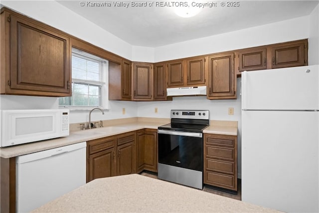 kitchen featuring sink and white appliances