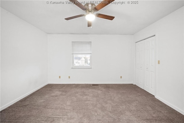 carpeted spare room featuring ceiling fan