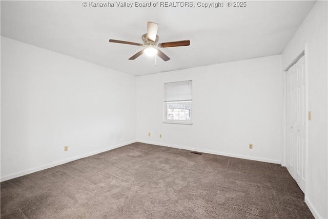 carpeted spare room featuring ceiling fan