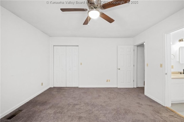 unfurnished bedroom featuring a closet, ceiling fan, sink, and light colored carpet