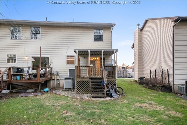 rear view of property with a lawn and central air condition unit