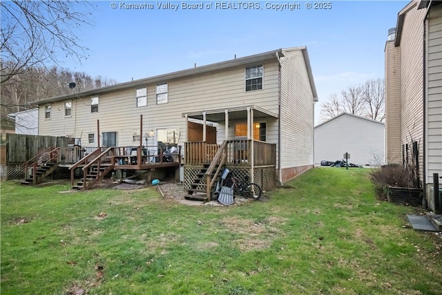 back of house featuring a lawn and a wooden deck