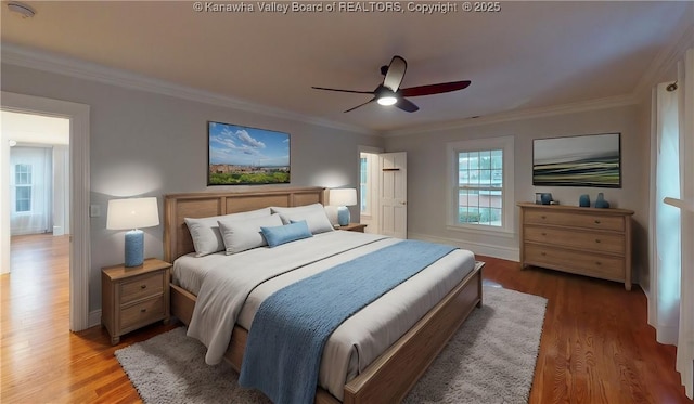 bedroom featuring hardwood / wood-style flooring, ceiling fan, and ornamental molding