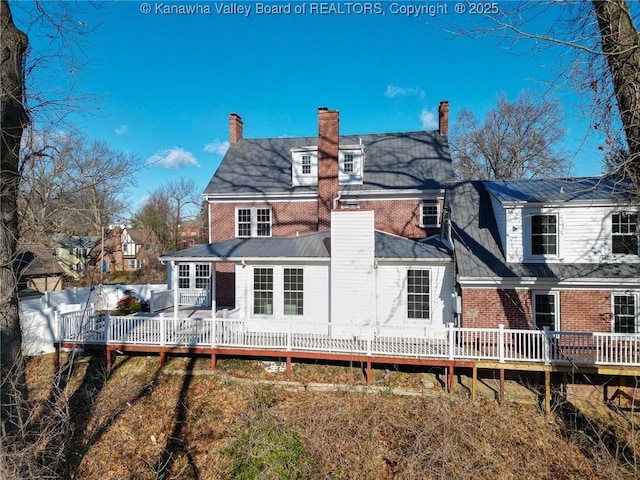 rear view of house featuring a deck