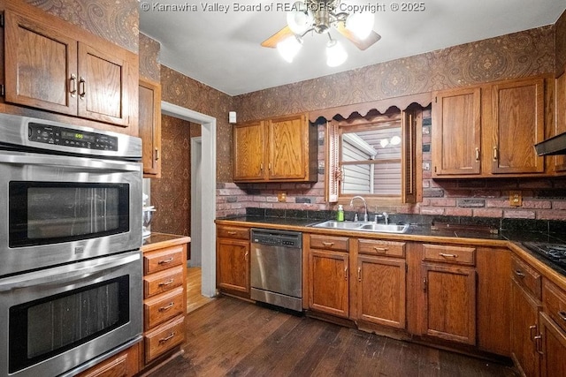 kitchen featuring sink, stainless steel appliances, and dark wood-type flooring