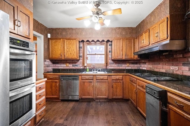 kitchen with tile counters, dark hardwood / wood-style floors, sink, and appliances with stainless steel finishes