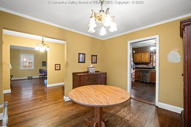 dining room featuring hardwood / wood-style floors, a chandelier, and ornamental molding