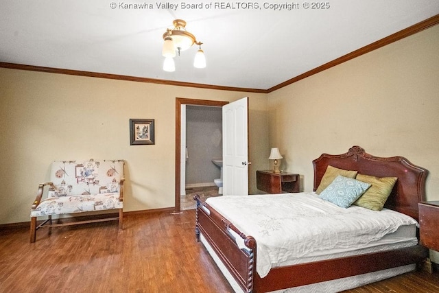 bedroom featuring a notable chandelier, wood-type flooring, ornamental molding, and connected bathroom