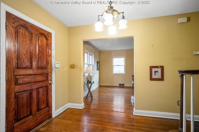 entrance foyer featuring a chandelier and dark hardwood / wood-style floors