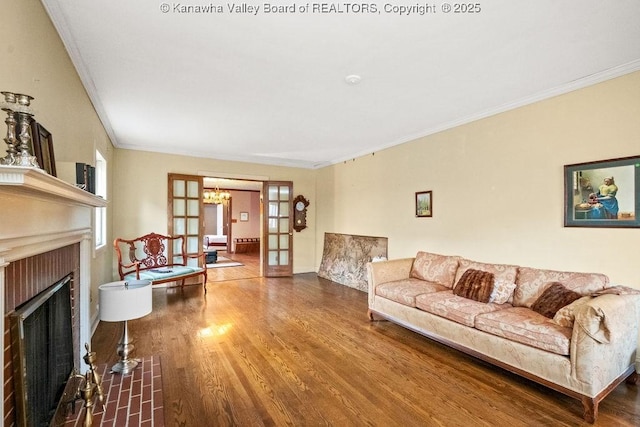 living room featuring french doors, crown molding, and wood-type flooring