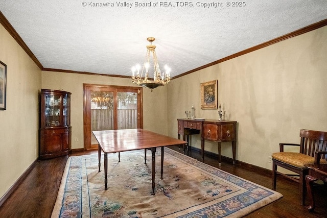 dining space featuring a textured ceiling, ornamental molding, dark wood-type flooring, and a chandelier