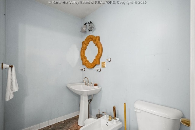 bathroom featuring toilet and a bidet