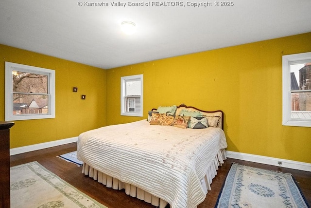 bedroom with dark hardwood / wood-style flooring