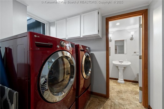 washroom featuring sink, ornamental molding, and washing machine and clothes dryer