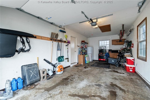 garage with a garage door opener and white refrigerator