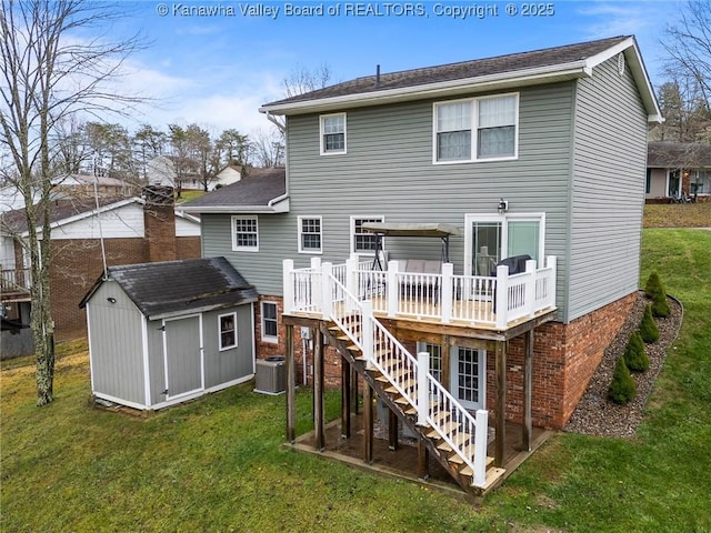 rear view of house featuring a yard, a shed, a deck, and central air condition unit