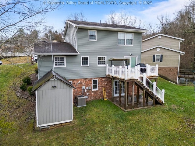 back of house featuring central AC, a yard, a deck, and a storage unit