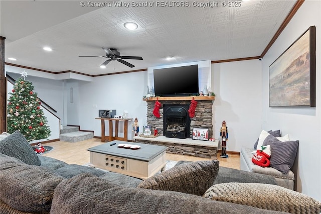 living room featuring a stone fireplace and ceiling fan