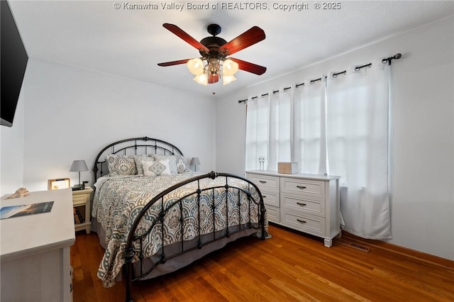 bedroom featuring ceiling fan and dark hardwood / wood-style floors