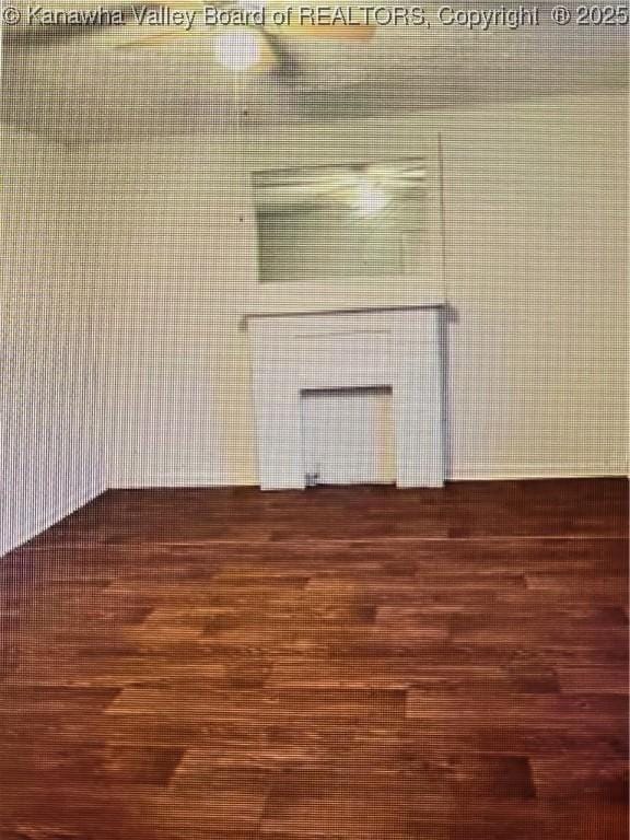 unfurnished living room featuring dark hardwood / wood-style floors