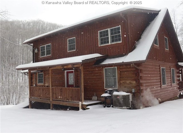 snow covered house with central air condition unit