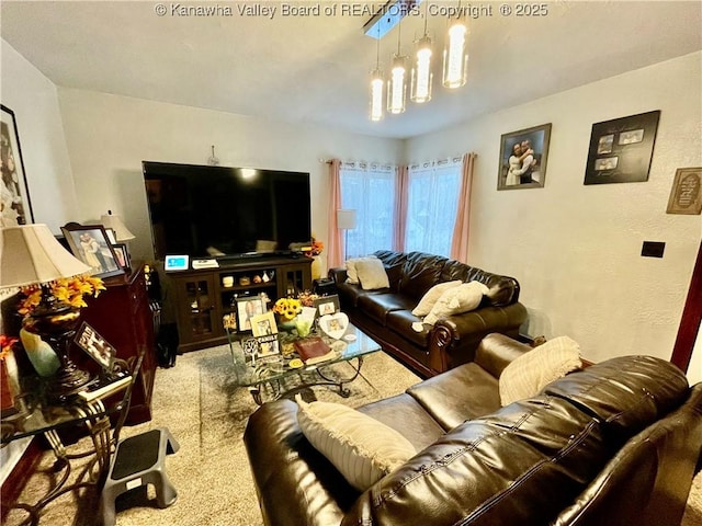 carpeted living room featuring a chandelier