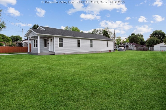 back of property featuring covered porch and a yard