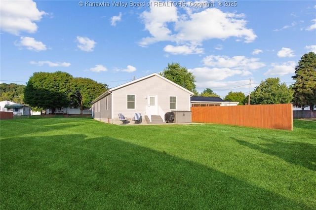 back of property featuring a yard